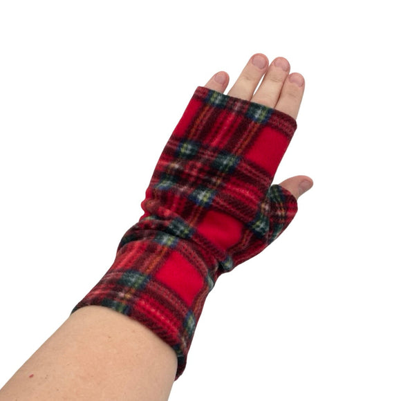 Red plaid fingerless gloves worn on a white background