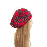 Red plaid beret on a mannequin head with long blonde hair against a white background