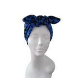 A blue and black patterned fabric headwrap styled on a white mannequin head against a plain white background.