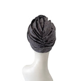 Gray turban on a mannequin head against a white background