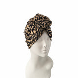 Leopard print headscarf on a mannequin head against a white background