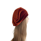 Brown beanie on a mannequin head with long hair against a white background