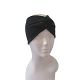 Black headband on a mannequin head against a white background
