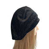 Black beanie on a mannequin head against a white background