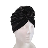Black turban on a mannequin head against a white background