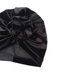 Black satin turban with a large bow on a white background