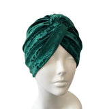 Green velvet turban on a mannequin head against a white background ireland