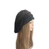 Black headscarf on a mannequin head with long hair against a white background
