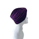 Purple turban on a mannequin head against a white background