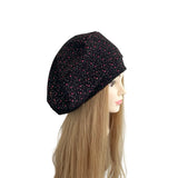 Black speckled beanie on a mannequin head with long blonde hair against a white background