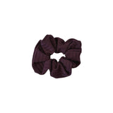 Dark purple scrunchie on a white background