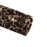 A leopard print fabric headband with a knotted twist detail, shown on a plain white background.