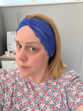 Person wearing a blue headband with a blurred background