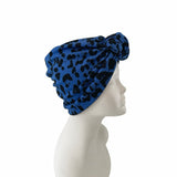 Blue leopard print headscarf on a mannequin head against a white background