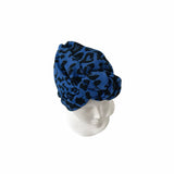 Blue leopard print headscarf on a mannequin head against a white background