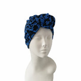 Blue leopard print headscarf on a mannequin head against a white background