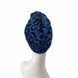 Blue patterned headscarf on a mannequin head against a white background