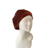Brown headscarf on a mannequin head against a white background