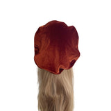 Brown velvet hair bun cover on a white background