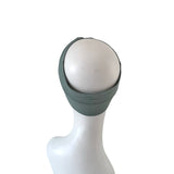 Mannequin head with a light gray wig on a white background