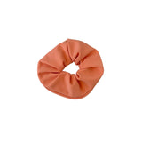 Orange scrunchie on a white background