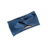 Blue knitted headband with a bow on a white background