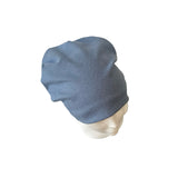 Blue beanie on a mannequin head against a white background
