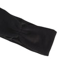 A close-up of a black fabric headband with a twisted knot detail, shown against a plain white background.