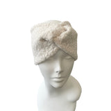 White fleece headband on a mannequin head against a white background
