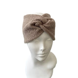 Brown headband on a mannequin head against a white background