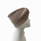 Brown fleece beanie on a mannequin head against a white background