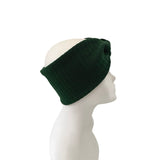 Green knit headband on a mannequin head against a white background
