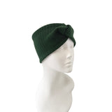 Green knit beanie on a mannequin head against a white background