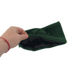 Hand holding a green knitted item against a white background