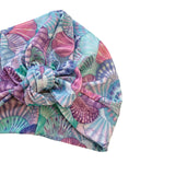 Colorful patterned headscarf with a bow on a white background