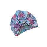 Colorful patterned headscarf with a knot on a white background