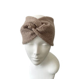 Brown knitted headband on a mannequin head against a white background