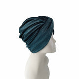 Blue knit turban on a mannequin head against a white background