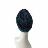 Blue velvet turban on a mannequin head against a white background