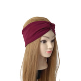 A long burgundy twisted headband displayed on a mannequin head with long light brown hair, set against a plain white background.