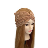 Mannequin head wearing a beige lace headband on a white background