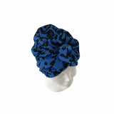 Blue patterned headscarf on a mannequin head against a white background