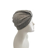 Gray headscarf on a mannequin head against a white background