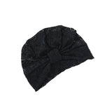 Black knitted headband with a bow on a white background
