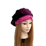 Mannequin head with a purple and pink headscarf on a white background
