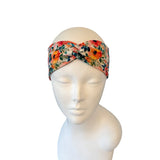 Floral patterned headband on a mannequin head against a white background