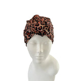 Leopard print headscarf on a mannequin head against a white background