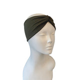 Dark green headband on a mannequin head against a white background