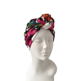 Colorful headscarf on a mannequin head against a white background