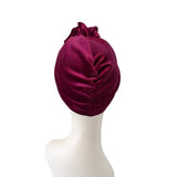 Maroon headscarf on a mannequin head against a white background